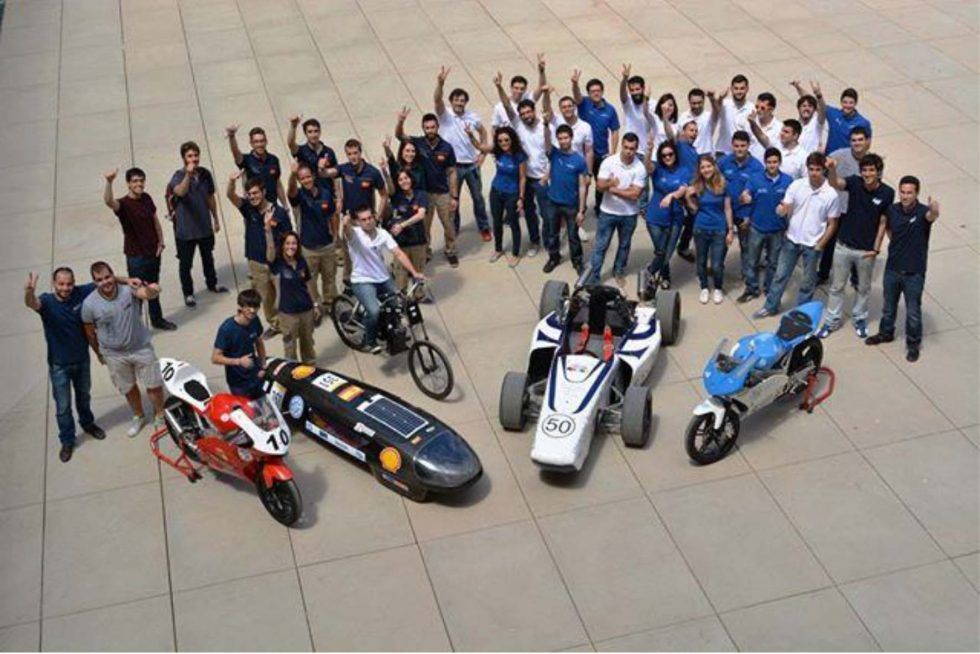 Group of students with prototypes of cars and motorcycles